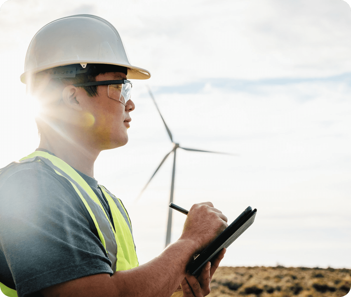 Worker inspecting wind energy site