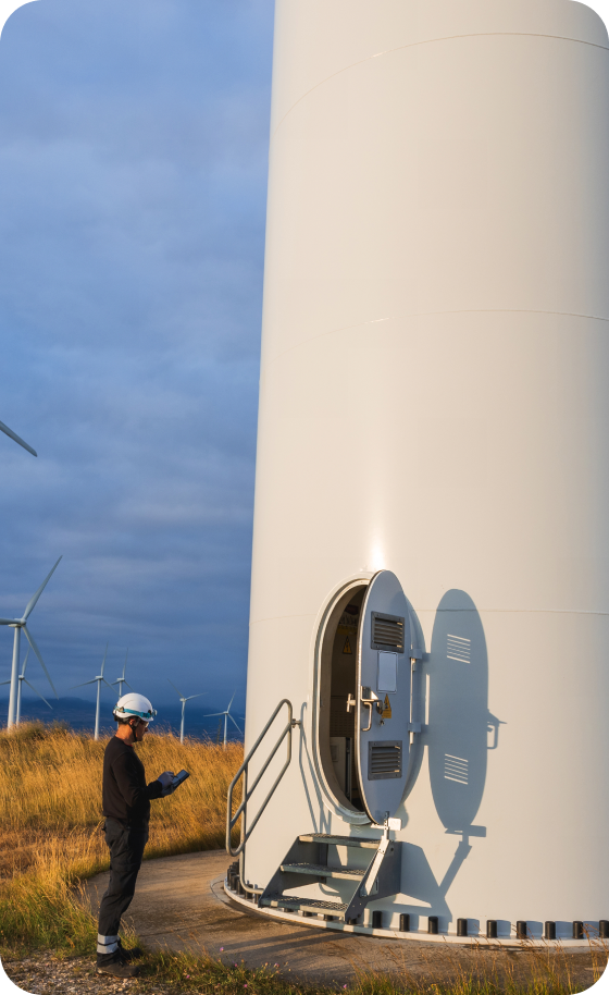 Worker inspecting wind turbine entrance
